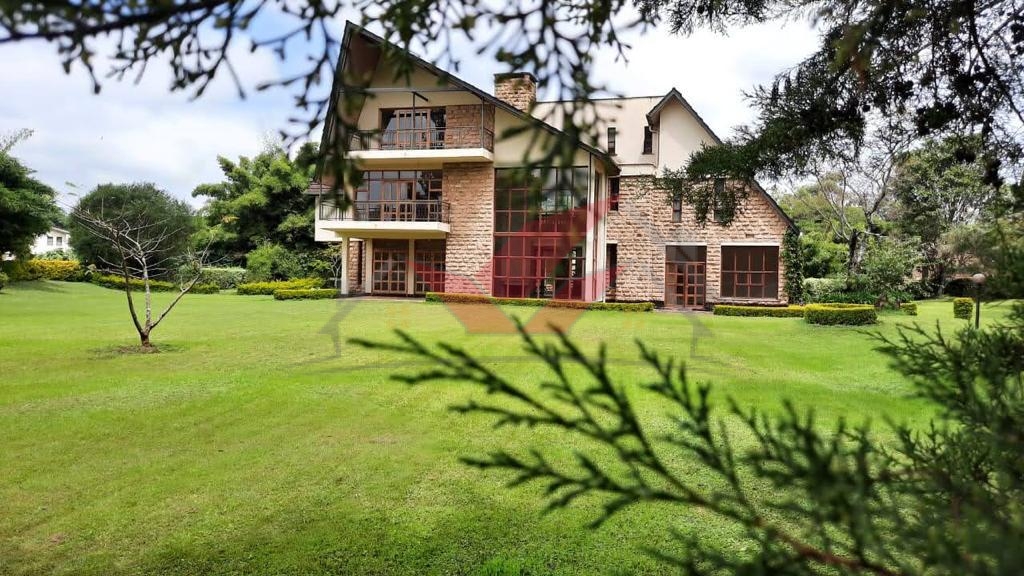 Luxury 5-bedroom villa for sale in a prestigious gated community in Karen, featuring ensuite bedrooms, expansive gardens, a communal swimming pool, clubhouse, gym, and breathtaking views of a man-made lake. The home includes modern amenities like a fitted kitchen, fireplace, and ample parking