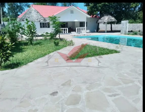 Newly Built 4-Bedroom All-Ensuite Bungalow with Swimming Pool for Sale in Prestigious Watamu – Ksh. 25M Location: Watamu, near Villa Watamu Plot Size: Half Acre Price: KSh 25 Million Contact: Call or WhatsApp +254 732 675057 Discover the epitome of coastal luxury with this newly built 4-bedroom all-ensuite bungalow, set on a spacious half-acre plot off Turtle Bay Road. Located in one of Watamu’s most exclusive neighborhoods, just a short stroll from pristine beaches, this home offers a perfect blend of modern elegance and coastal charm. ### Property Features: - 4 Ensuite Bedrooms: Each bedroom includes a private bathroom for comfort and privacy. - Spacious Living Area: Bathed in natural light, ideal for relaxation and entertaining. - Modern Open Kitchen: Fully fitted with high-quality appliances and granite countertops, perfect for family gatherings. - Additional Guest Bathroom: Enhances the home’s functionality. - Private Swimming Pool: Perfect for leisure and entertaining. - Two Makuti Gazebos: Traditional shaded spaces for relaxation and socializing. - Manicured Garden: Lush, vibrant landscaping with mature trees for natural shade. - Low Maintenance Roof: Durable roofing ensures longevity with minimal upkeep. - Quiet, Serene Neighborhood: Located in a peaceful area with easy beach access. ### Prime Location & Highlights: - Walking Distance to the Beach: Enjoy morning strolls and sunsets with nearby beach access. - Near Upscale Amenities: Close to Villa Watamu, fine dining, and recreational options. Why This Property? This newly built bungalow is a rare opportunity to own a luxurious and peaceful home in one of Watamu’s most desirable neighborhoods. Perfect for a family residence, holiday retreat, or investment, this property meets every need. #WatamuBungalow #BeachLife #WatamuRealEstate #LuxuryHomes #KenyaProperty #DreamHome #CoastalLiving #ModernVilla #WatamuLuxury #KenyaBungalow #HolidayHomeKenya #InvestInWatamu #EastAfricaRealEstate #VacationHomeKenya #WatamuBeachHouse #LuxuryLivingKenya #PrimePropertyKenya #ExpatHomesKenya #KenyaHolidayHomes #NewHomesKenya #LuxuryRetreatKenya #CoastalGetawayKenya #InvestInKenya #PrivatePoolLiving