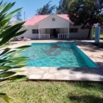 Newly Built 4-Bedroom All-Ensuite Bungalow with Swimming Pool for Sale in Prestigious Watamu -- Ksh. 25M Location: Watamu, near Villa Watamu Plot Size: Half Acre Price: KSh 25 Million Contact: Call or WhatsApp +254 732 675057 Discover the epitome of coastal luxury with this newly built 4-bedroom all-ensuite bungalow, set on a spacious half-acre plot off Turtle Bay Road. Located in one of Watamu's most exclusive neighborhoods, just a short stroll from pristine beaches, this home offers a perfect blend of modern elegance and coastal charm. ### Property Features: - 4 Ensuite Bedrooms: Each bedroom includes a private bathroom for comfort and privacy. - Spacious Living Area: Bathed in natural light, ideal for relaxation and entertaining. - Modern Open Kitchen: Fully fitted with high-quality appliances and granite countertops, perfect for family gatherings. - Additional Guest Bathroom: Enhances the home's functionality. - Private Swimming Pool: Perfect for leisure and entertaining. - Two Makuti Gazebos: Traditional shaded spaces for relaxation and socializing. - Manicured Garden: Lush, vibrant landscaping with mature trees for natural shade. - Low Maintenance Roof: Durable roofing ensures longevity with minimal upkeep. - Quiet, Serene Neighborhood: Located in a peaceful area with easy beach access. ### Prime Location & Highlights: - Walking Distance to the Beach: Enjoy morning strolls and sunsets with nearby beach access. - Near Upscale Amenities: Close to Villa Watamu, fine dining, and recreational options. Why This Property? This newly built bungalow is a rare opportunity to own a luxurious and peaceful home in one of Watamu's most desirable neighborhoods. Perfect for a family residence, holiday retreat, or investment, this property meets every need. #WatamuBungalow #BeachLife #WatamuRealEstate #LuxuryHomes #KenyaProperty #DreamHome #CoastalLiving #ModernVilla #WatamuLuxury #KenyaBungalow #HolidayHomeKenya #InvestInWatamu #EastAfricaRealEstate #VacationHomeKenya #WatamuBeachHouse #LuxuryLivingKenya #PrimePropertyKenya #ExpatHomesKenya #KenyaHolidayHomes #NewHomesKenya #LuxuryRetreatKenya #CoastalGetawayKenya #InvestInKenya #PrivatePoolLiving