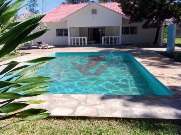 Newly Built 4-Bedroom All-Ensuite Bungalow with Swimming Pool for Sale in Prestigious Watamu -- Ksh. 25M Location: Watamu, near Villa Watamu Plot Size: Half Acre Price: KSh 25 Million Contact: Call or WhatsApp +254 732 675057 Discover the epitome of coastal luxury with this newly built 4-bedroom all-ensuite bungalow, set on a spacious half-acre plot off Turtle Bay Road. Located in one of Watamu's most exclusive neighborhoods, just a short stroll from pristine beaches, this home offers a perfect blend of modern elegance and coastal charm. ### Property Features: - 4 Ensuite Bedrooms: Each bedroom includes a private bathroom for comfort and privacy. - Spacious Living Area: Bathed in natural light, ideal for relaxation and entertaining. - Modern Open Kitchen: Fully fitted with high-quality appliances and granite countertops, perfect for family gatherings. - Additional Guest Bathroom: Enhances the home's functionality. - Private Swimming Pool: Perfect for leisure and entertaining. - Two Makuti Gazebos: Traditional shaded spaces for relaxation and socializing. - Manicured Garden: Lush, vibrant landscaping with mature trees for natural shade. - Low Maintenance Roof: Durable roofing ensures longevity with minimal upkeep. - Quiet, Serene Neighborhood: Located in a peaceful area with easy beach access. ### Prime Location & Highlights: - Walking Distance to the Beach: Enjoy morning strolls and sunsets with nearby beach access. - Near Upscale Amenities: Close to Villa Watamu, fine dining, and recreational options. Why This Property? This newly built bungalow is a rare opportunity to own a luxurious and peaceful home in one of Watamu's most desirable neighborhoods. Perfect for a family residence, holiday retreat, or investment, this property meets every need. #WatamuBungalow #BeachLife #WatamuRealEstate #LuxuryHomes #KenyaProperty #DreamHome #CoastalLiving #ModernVilla #WatamuLuxury #KenyaBungalow #HolidayHomeKenya #InvestInWatamu #EastAfricaRealEstate #VacationHomeKenya #WatamuBeachHouse #LuxuryLivingKenya #PrimePropertyKenya #ExpatHomesKenya #KenyaHolidayHomes #NewHomesKenya #LuxuryRetreatKenya #CoastalGetawayKenya #InvestInKenya #PrivatePoolLiving