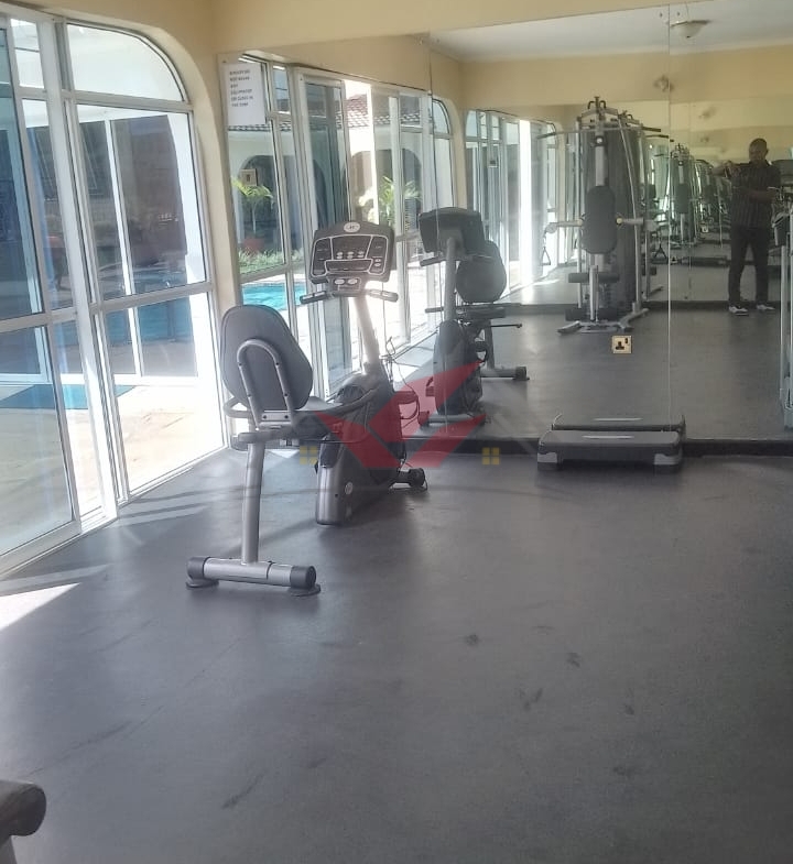 Front view of elegant 3-bedroom all-ensuite house for rent in Karen Bogani, featuring a gated entrance, lush landscaping, and modern design.