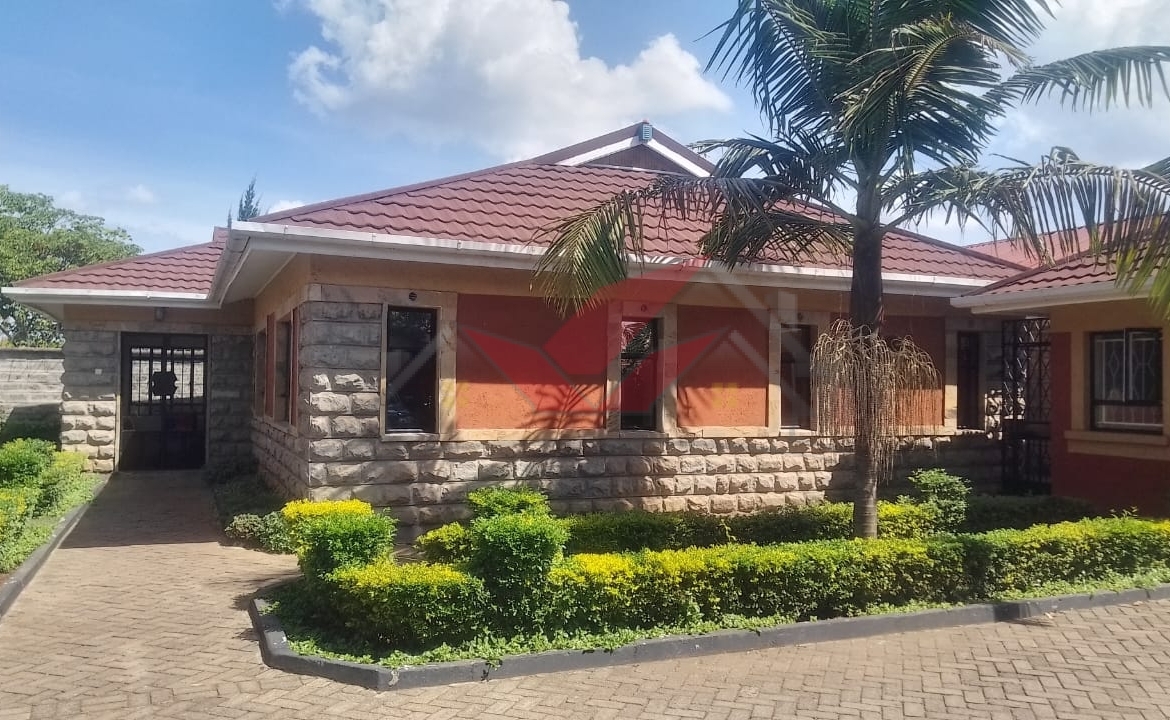 Front view of elegant 3-bedroom all-ensuite house for rent in Karen Bogani, featuring a gated entrance, lush landscaping, and modern design.