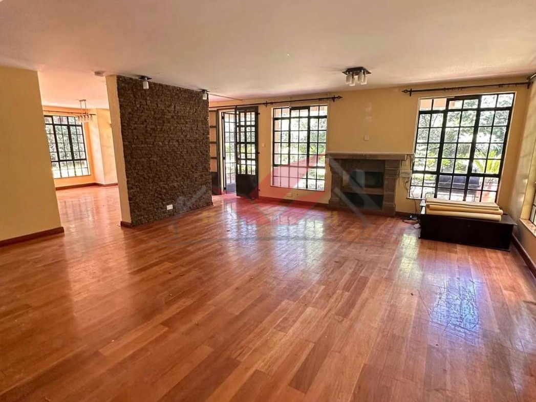 Grand living room with hardwood floors and fireplace in a luxury Karen rental.
