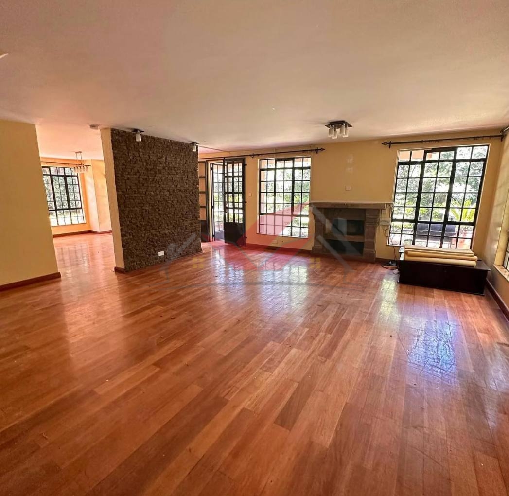Grand living room with hardwood floors and fireplace in a luxury Karen rental.