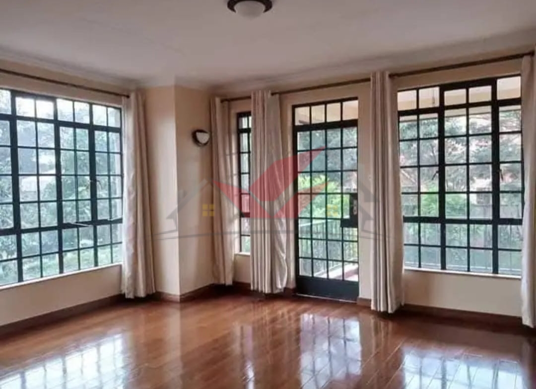 Grand living room with hardwood floors and fireplace in a luxury Karen rental.