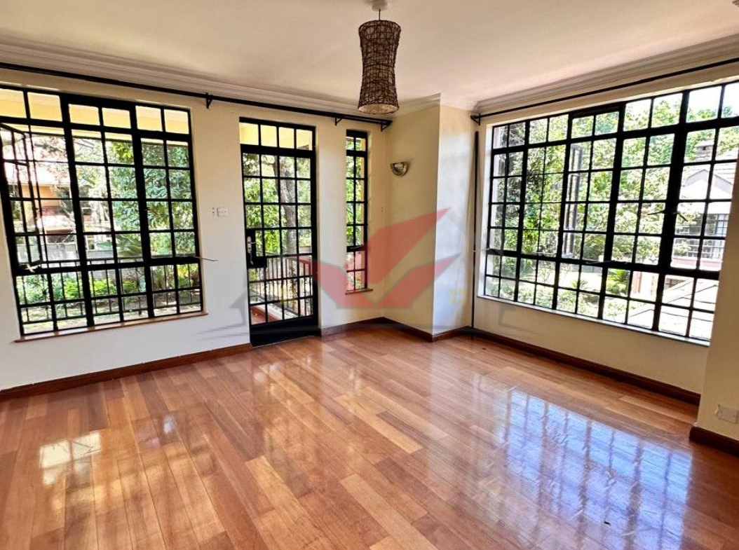 Grand living room with hardwood floors and fireplace in a luxury Karen rental.