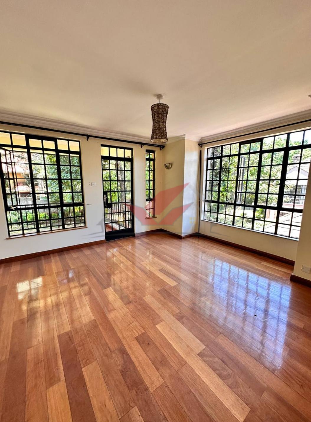 Grand living room with hardwood floors and fireplace in a luxury Karen rental.