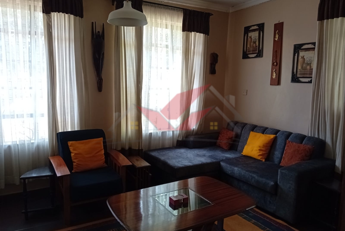 Cozy fully furnished living room and bedroom of a 1-bedroom rental cottage in Miotoni Karen Nairobi.