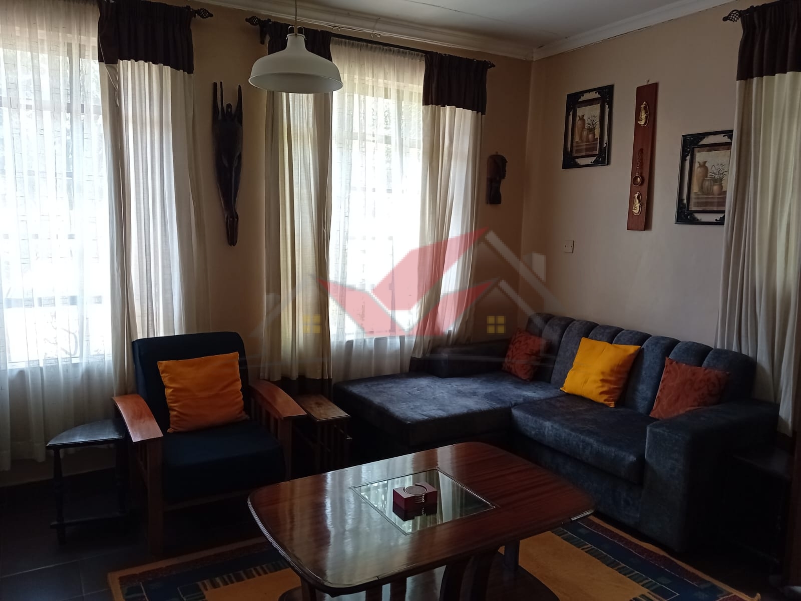 Cozy fully furnished living room and bedroom of a 1-bedroom rental cottage in Miotoni Karen Nairobi.