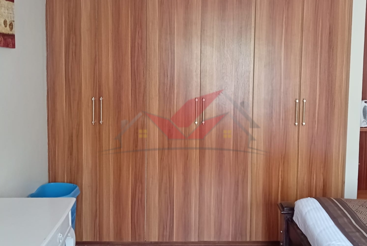 Cozy fully furnished living room and bedroom of a 1-bedroom rental cottage in Miotoni Karen Nairobi.