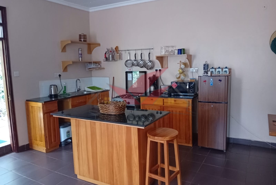 Cozy fully furnished living room and bedroom of a 1-bedroom rental cottage in Miotoni Karen Nairobi.