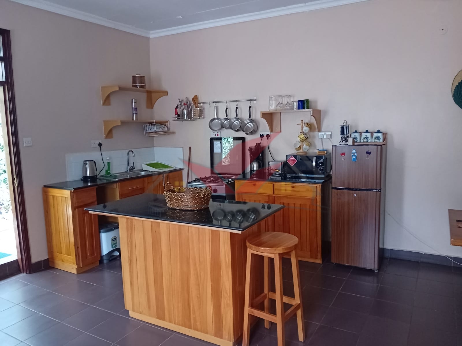Cozy fully furnished living room and bedroom of a 1-bedroom rental cottage in Miotoni Karen Nairobi.
