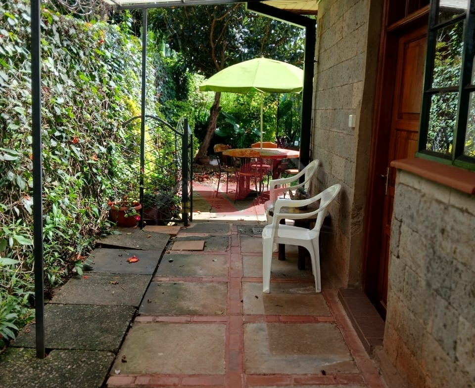Cozy fully furnished living room and bedroom of a 1-bedroom rental cottage in Miotoni Karen Nairobi.