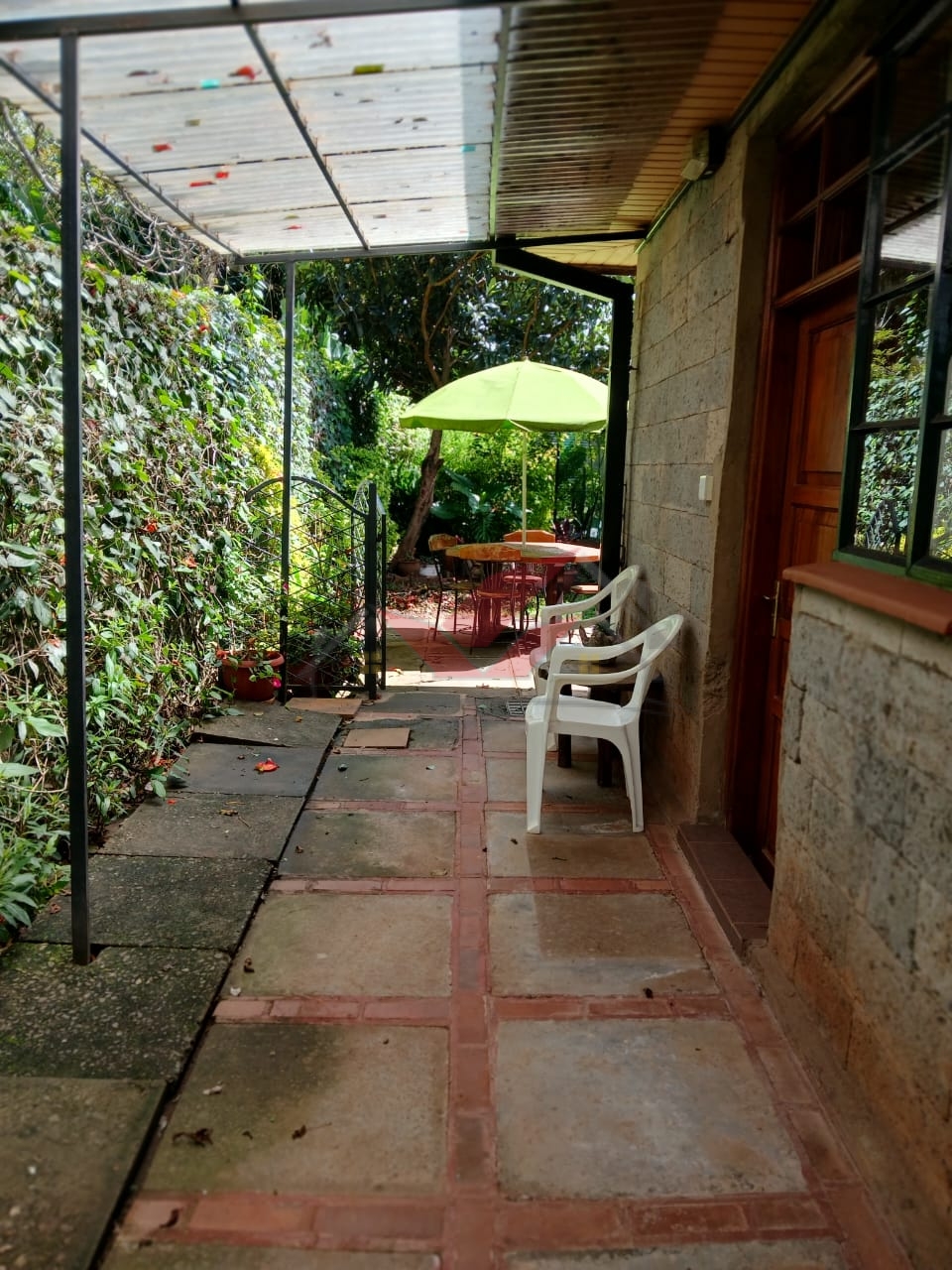 Cozy fully furnished living room and bedroom of a 1-bedroom rental cottage in Miotoni Karen Nairobi.